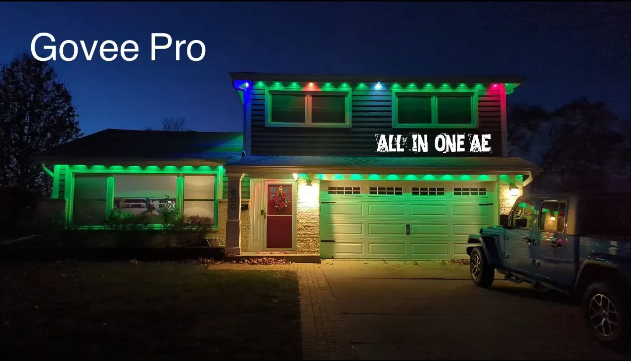 Two-story house at night with Govee Pro permanent RGB lighting installed along the roofline